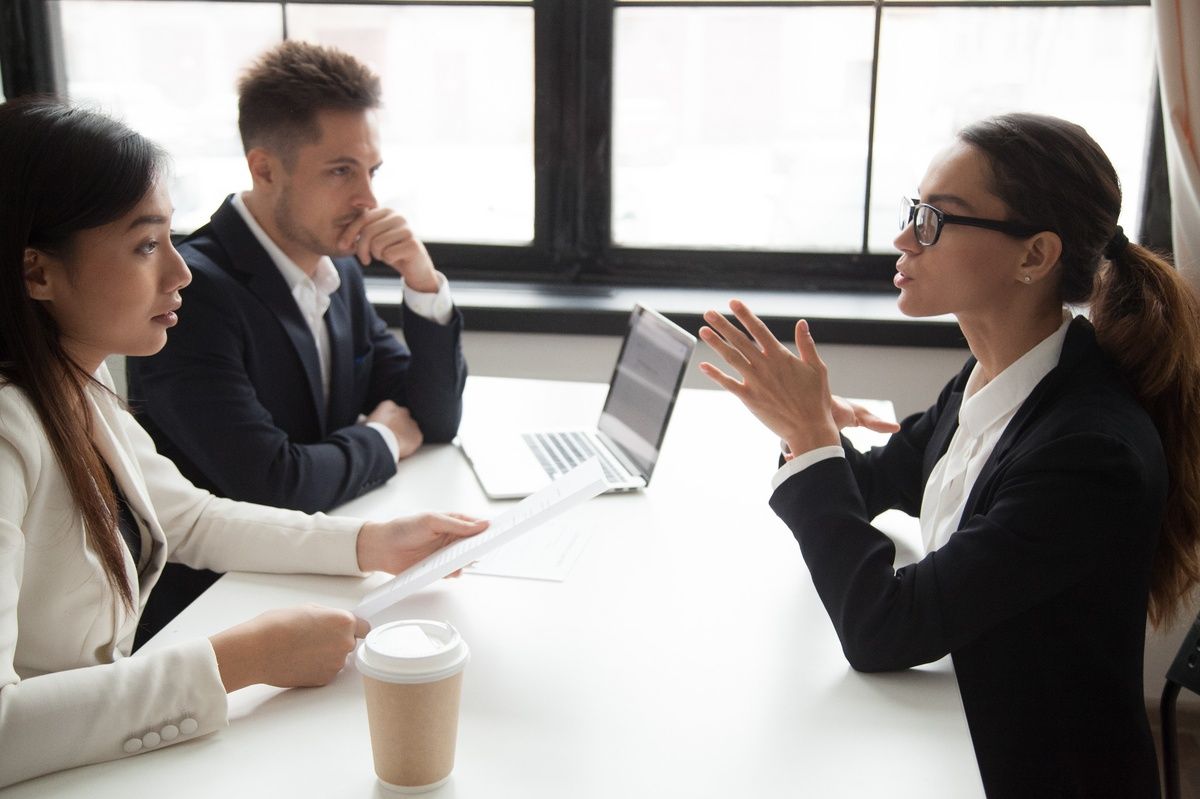 Business discussion between 3 people
