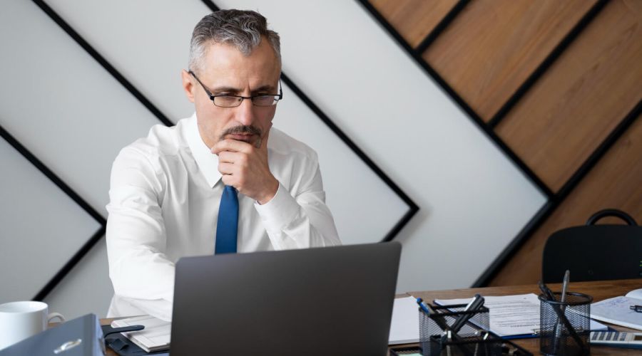 Medium shot man working on laptop