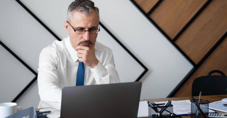 Medium shot man working on laptop
